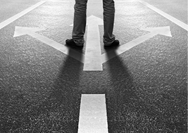 Image of person standing on path that splits three ways