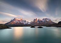 Sunrise over a calm lake and mountians