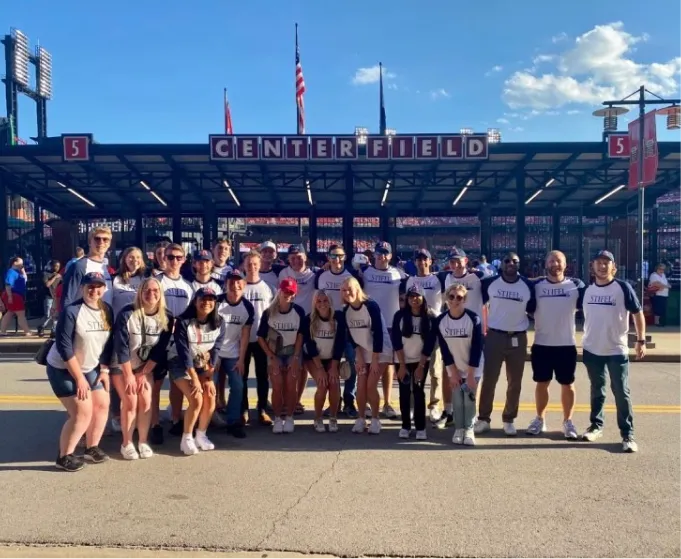 Large group of interns in front of Busch Stadium
