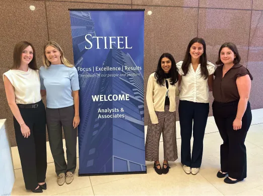 Interns standing in front of a welcome banner