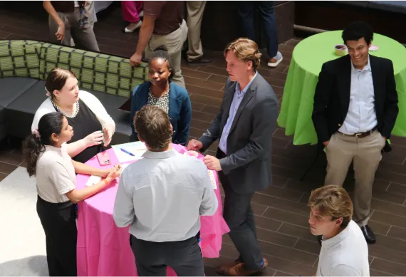 Interns gathered around a table discussing their experiences