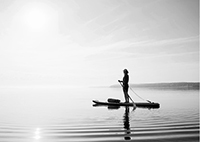 Woman on a paddle board in a calm lake