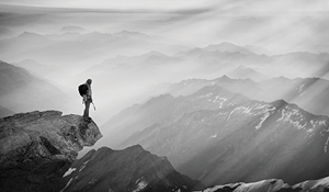 Mountain climber looking at landscape from mountain peak